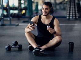 Young Man Consuming Protein Bar After Gym for Muscle Recovery